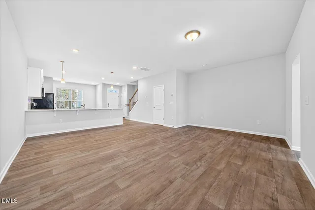 a view of walk in closet with wooden floor