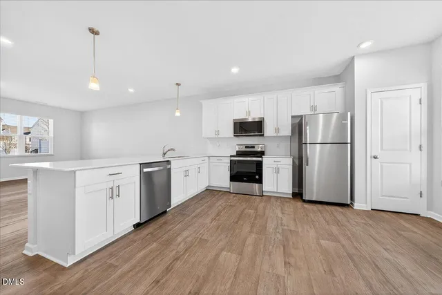 a kitchen with a refrigerator stove and microwave