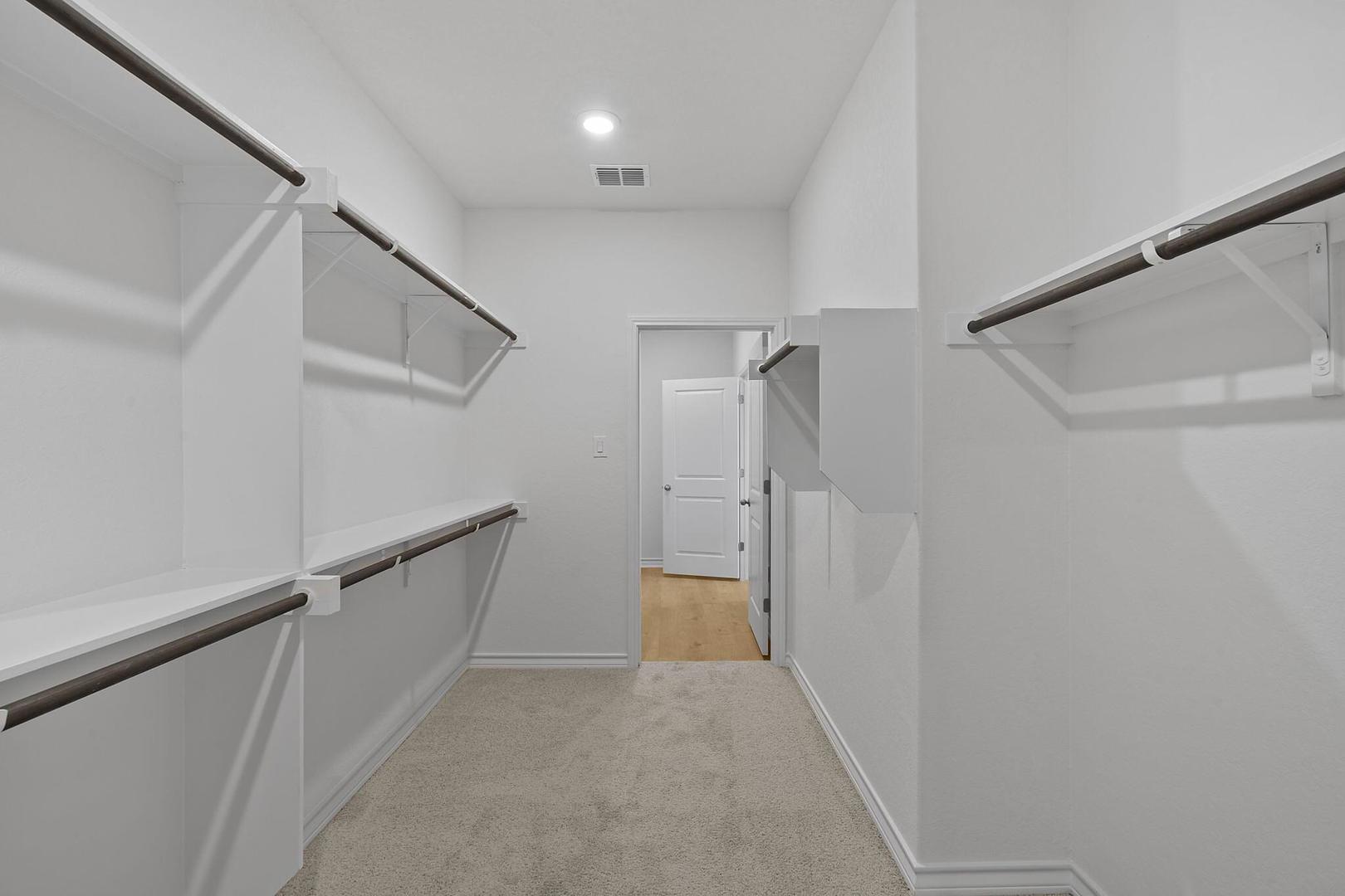 109 Hatari Trail Jarrell, TX 76537 - Photo 15 of 31 Ample shelving and hanging space defines this well-organized walk-in closet.