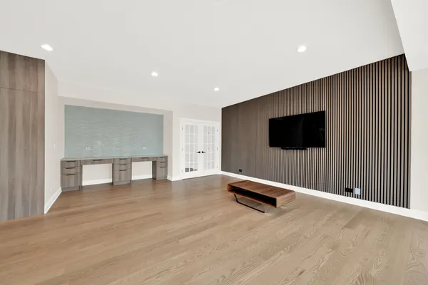 a bedroom with furniture and a large window