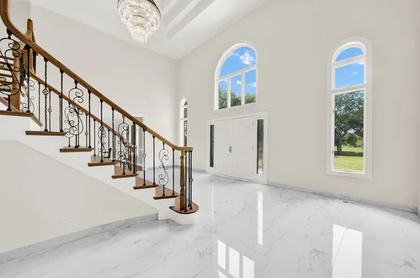 a view of an empty room with glass door and furniture