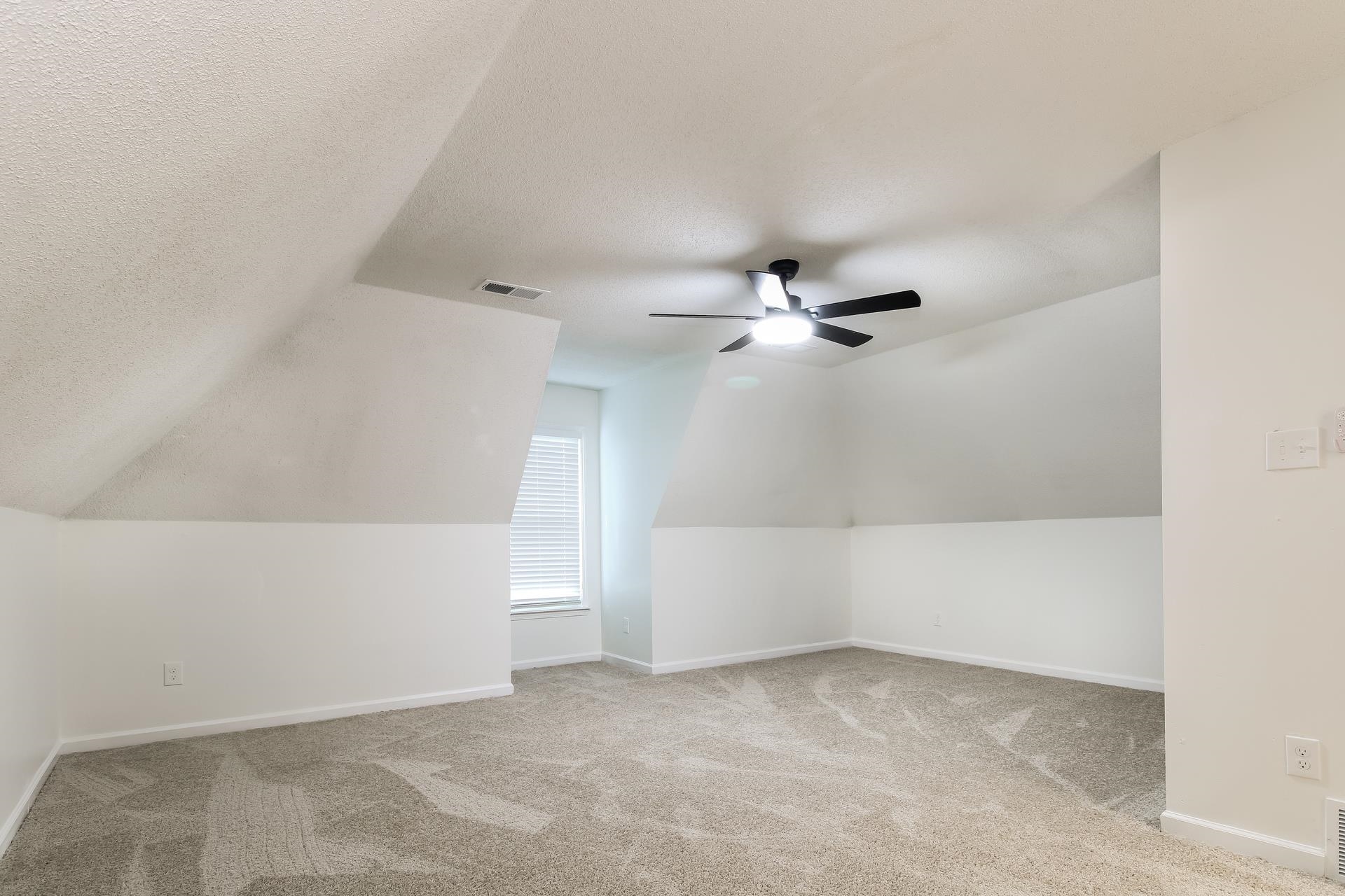 8729 Dexter Road Memphis, TN 38016 - Photo 12 of 20 Bonus room with light colored carpet, lofted ceiling, a textured ceiling, and ceiling fan