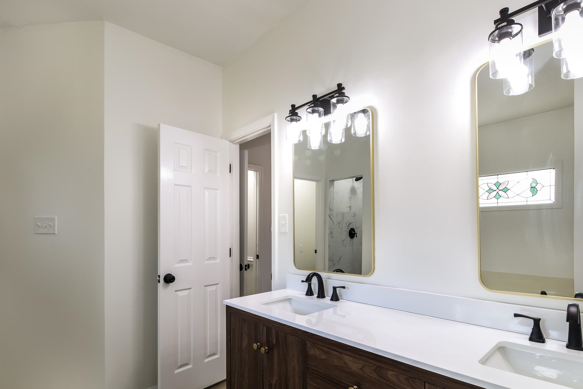 8729 Dexter Road Memphis, TN 38016 - Photo 15 of 20 Full bathroom featuring double vanity and a shower