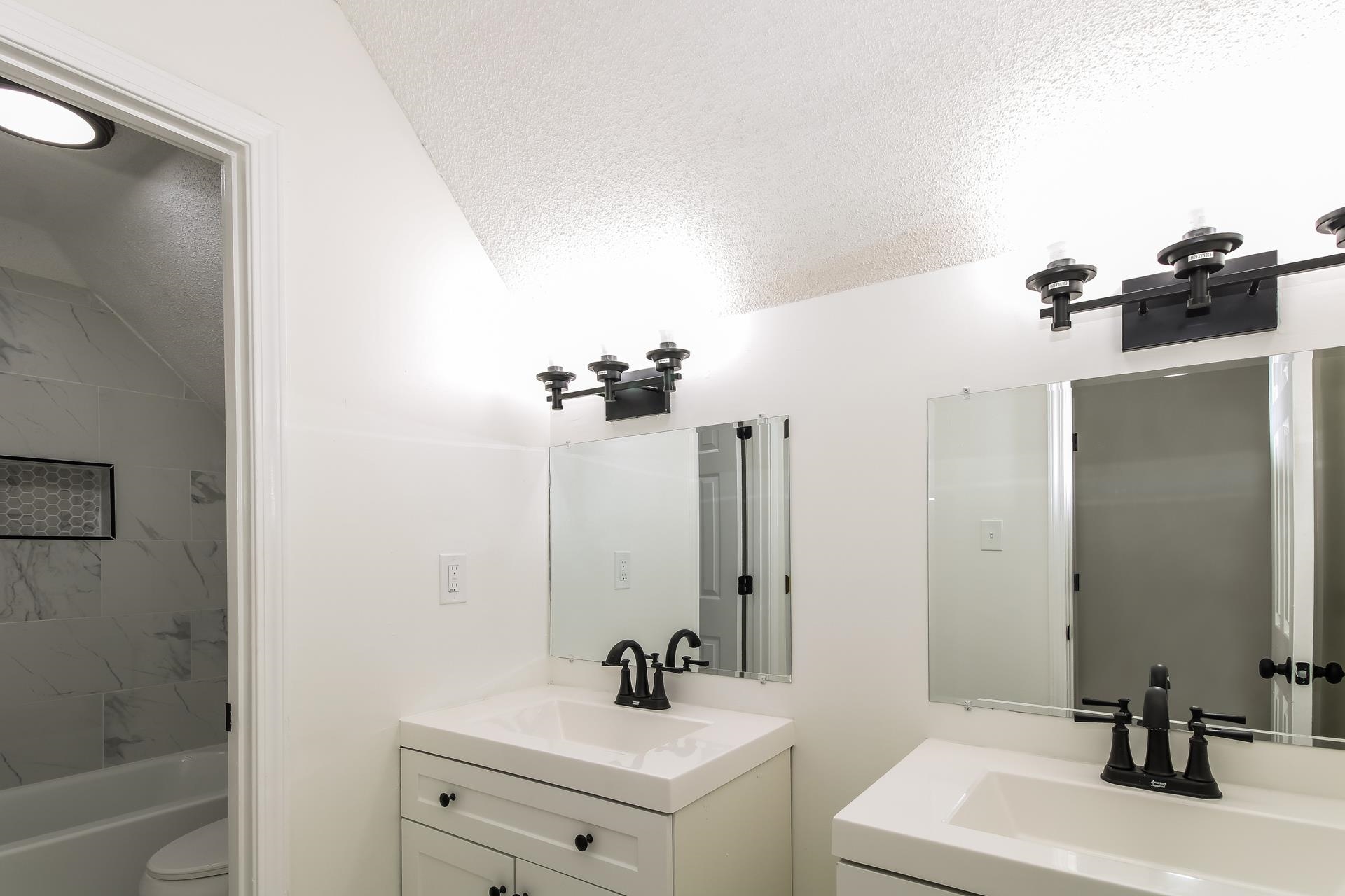 8729 Dexter Road Memphis, TN 38016 - Photo 17 of 20 Bathroom featuring vanity, tub / shower combination, and a textured ceiling