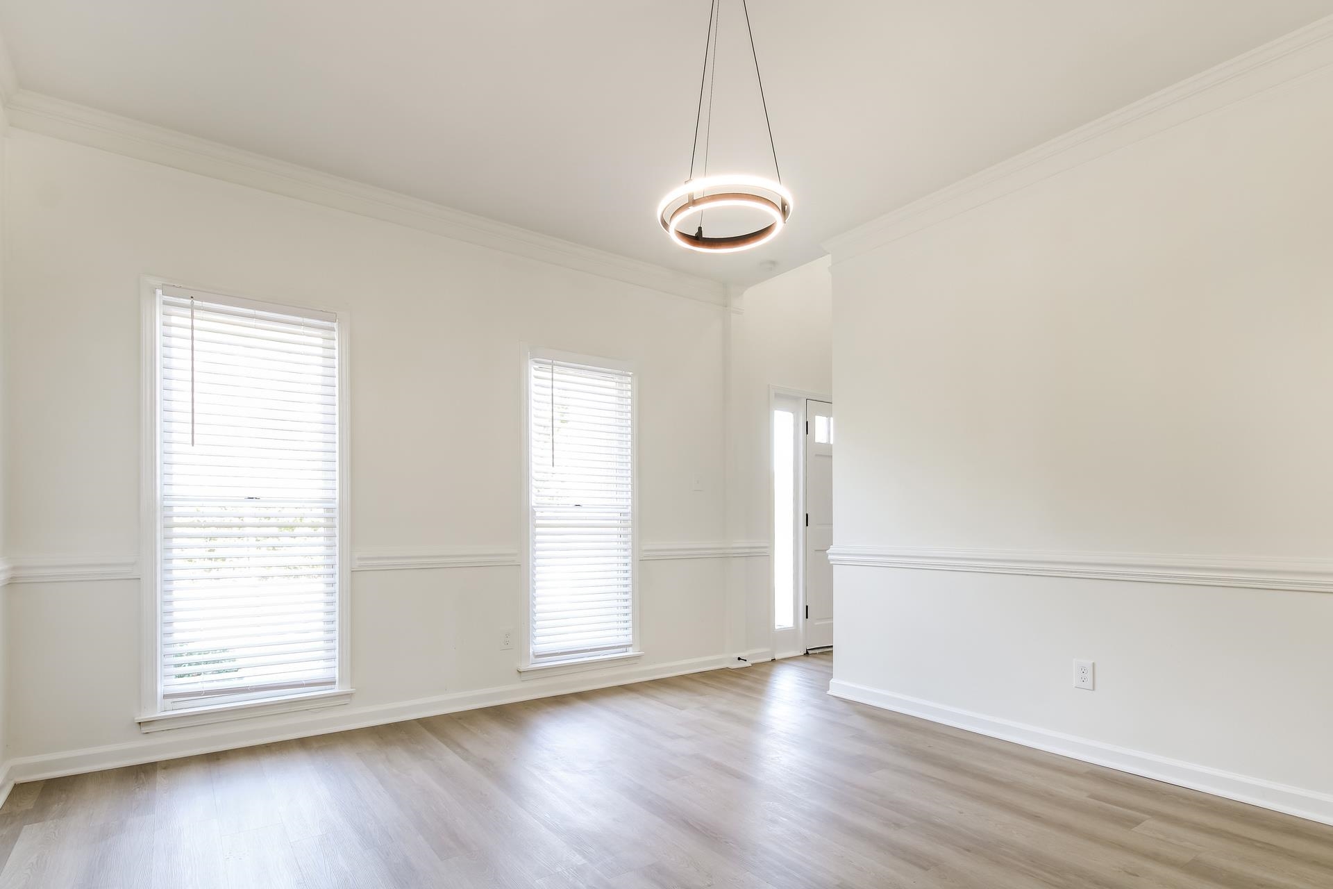 Spare room featuring ornamental molding and light wood-style floors