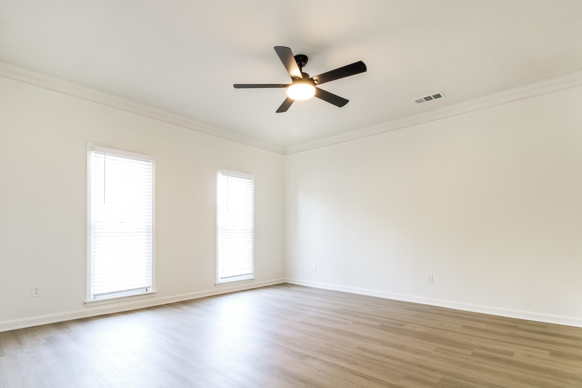 8729 Dexter Road Memphis, TN 38016 - Photo 9 of 20 Empty room featuring light wood-style floors, ornamental molding, and ceiling fan