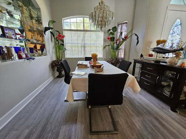 a dining room with furniture and wooden floor