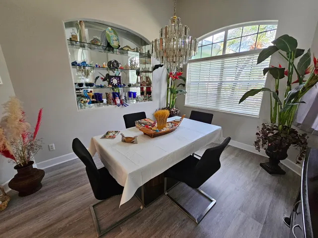 a view of a dining room with furniture and wooden floor
