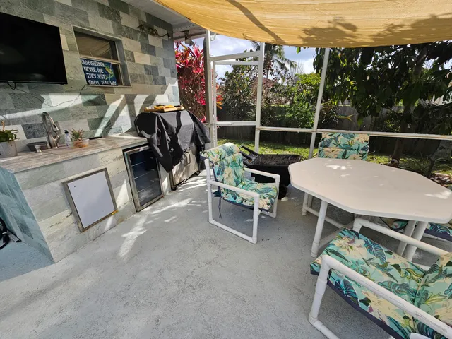 a view of a patio with a table and chairs