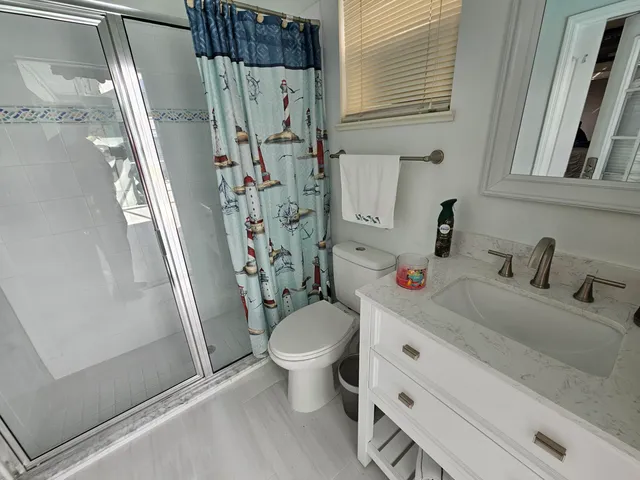 a bathroom with a sink toilet and shower
