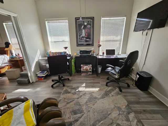 a view of a livingroom with workspace and a window