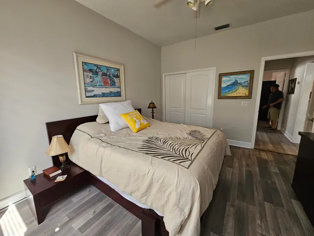 a bedroom with a bed and wooden floor
