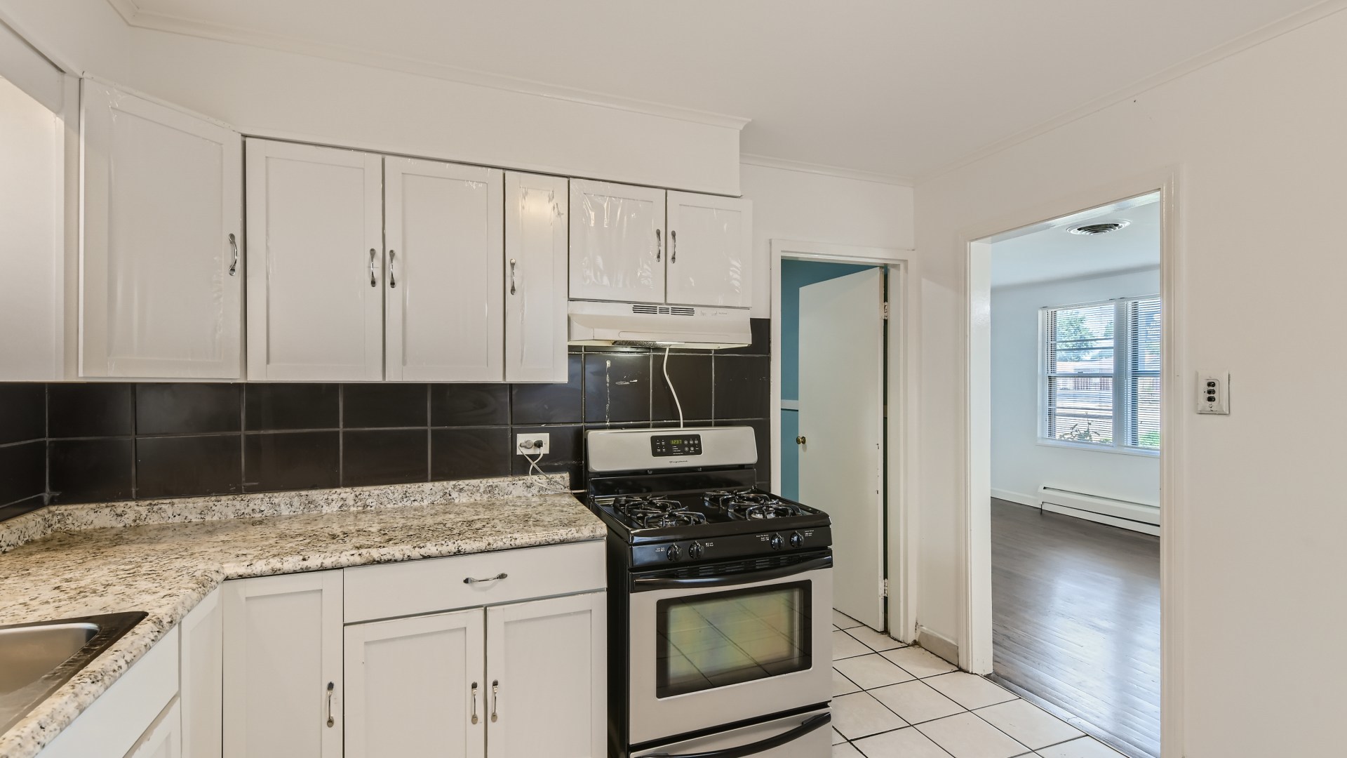 10718 South Pulaski Road Oak Lawn, IL 60453 - Photo 12 of 28 a kitchen with granite countertop a stove and a sink