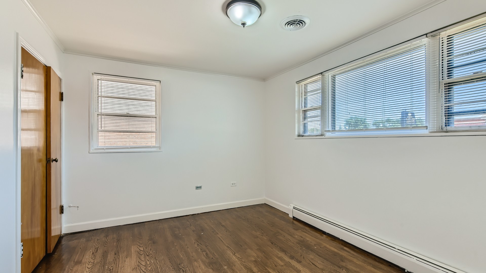 10718 South Pulaski Road Oak Lawn, IL 60453 - Photo 14 of 28 a view of an empty room with wooden floor and a window