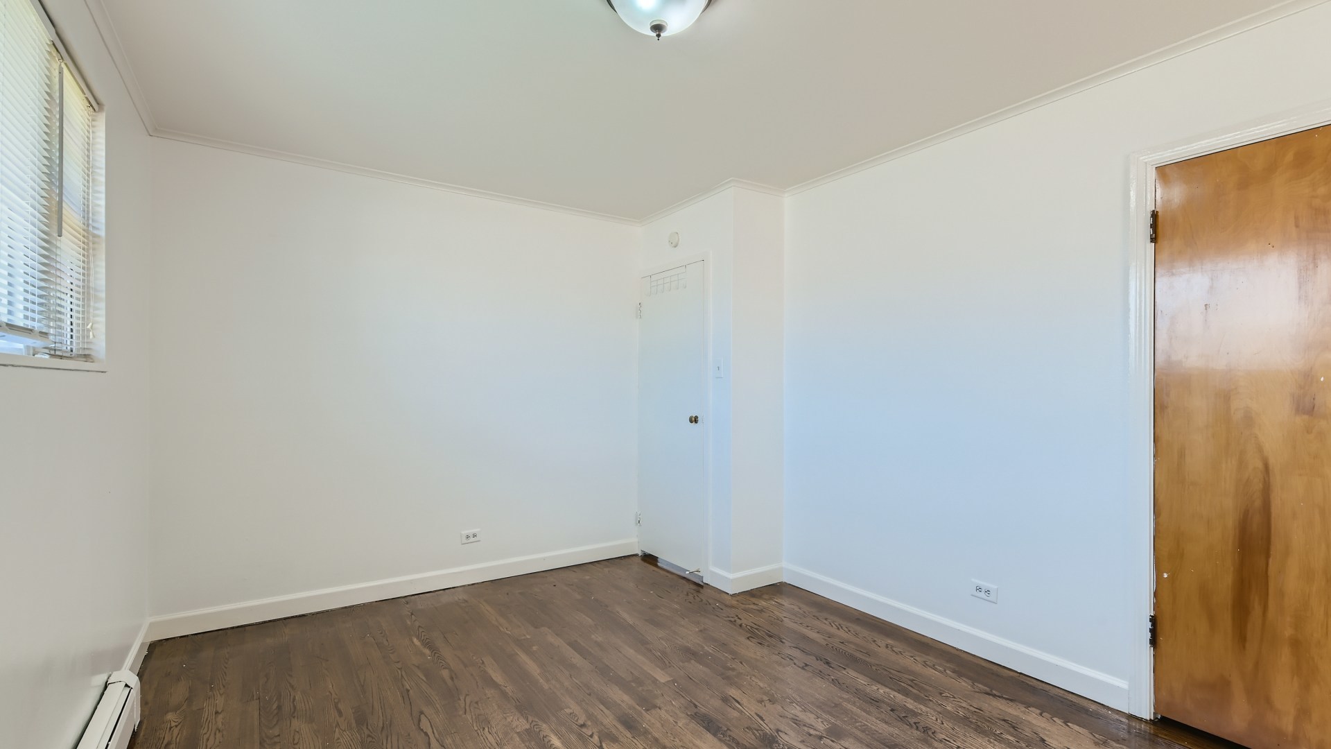 10718 South Pulaski Road Oak Lawn, IL 60453 - Photo 16 of 28 a view of an empty room with wooden floor and a window