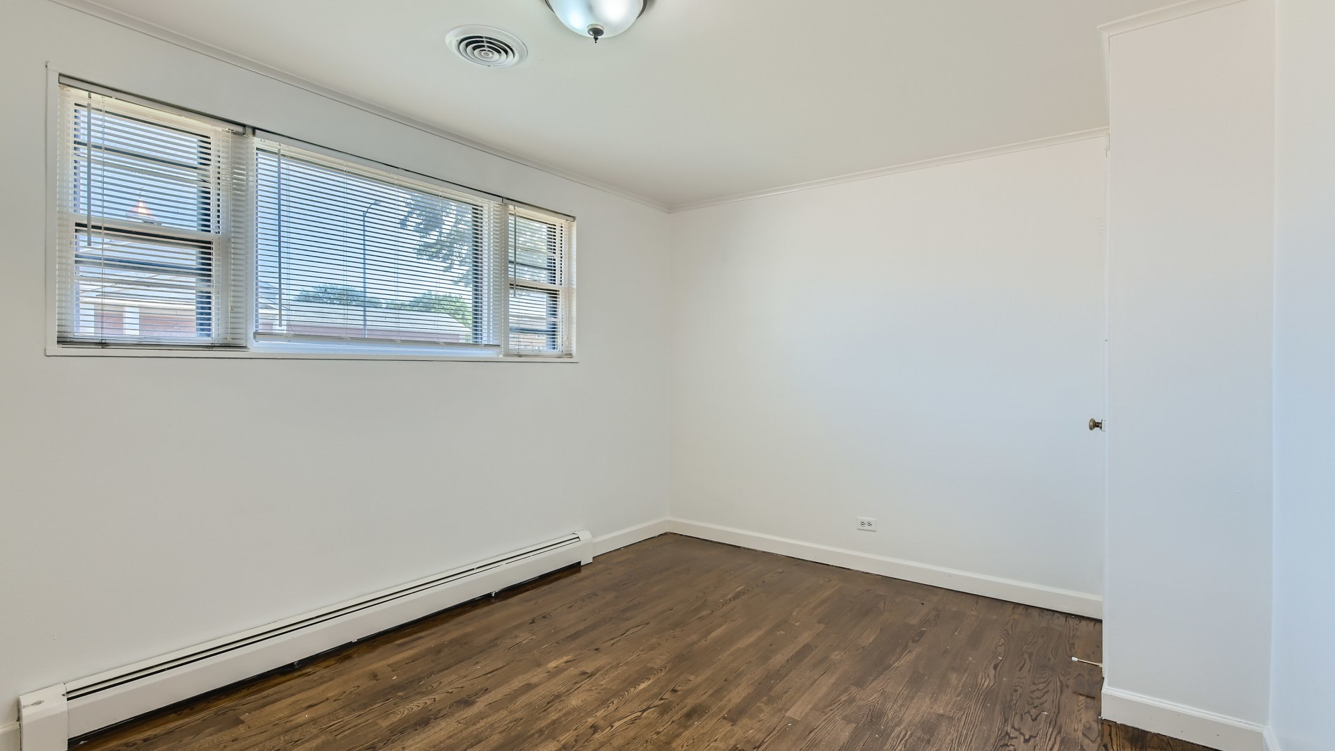 10718 South Pulaski Road Oak Lawn, IL 60453 - Photo 17 of 28 an empty room with wooden floor and windows