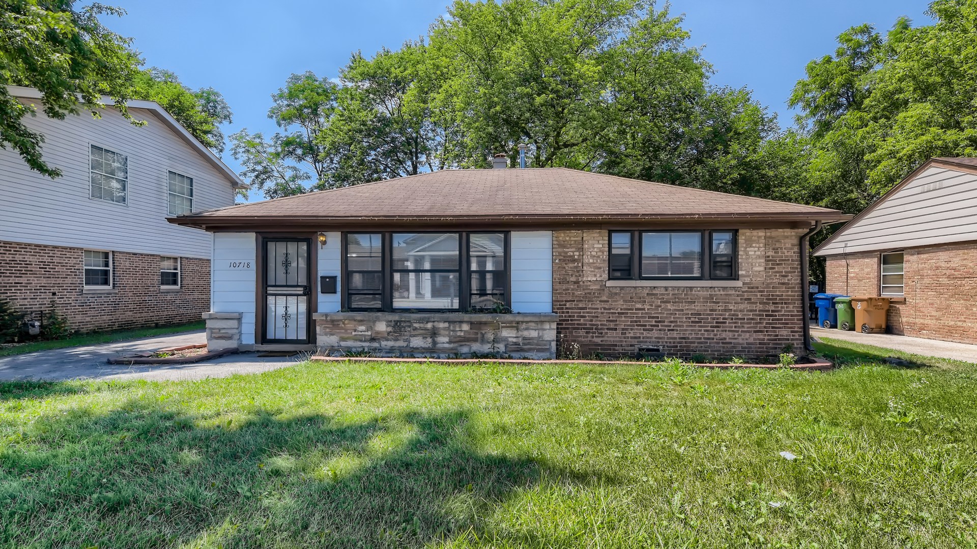 10718 South Pulaski Road Oak Lawn, IL 60453 - Photo 2 of 28 a front view of a house with a yard and porch