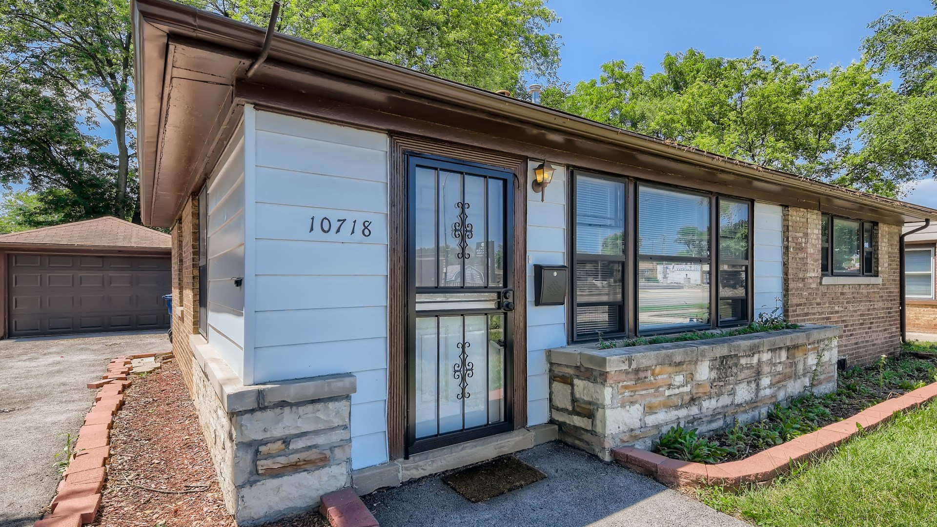 10718 South Pulaski Road Oak Lawn, IL 60453 - Photo 3 of 28 a front view of a house with a garden