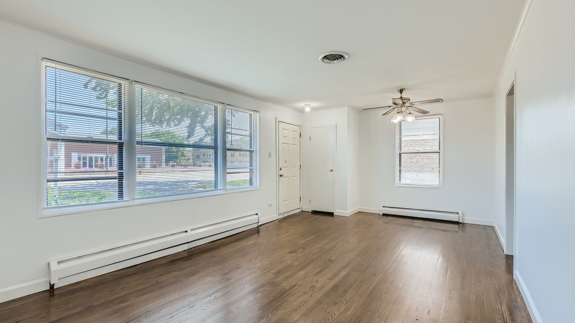 10718 South Pulaski Road Oak Lawn, IL 60453 - Photo 5 of 28 an empty room with wooden floor and windows