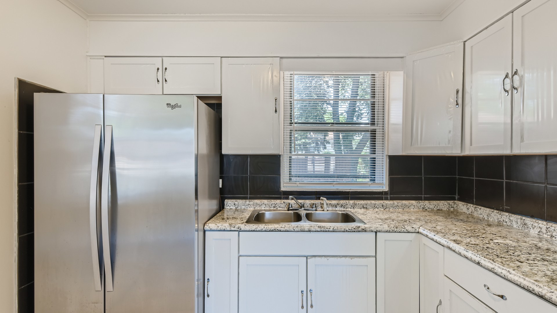 10718 South Pulaski Road Oak Lawn, IL 60453 - Photo 10 of 28 a kitchen with granite countertop a sink and a refrigerator