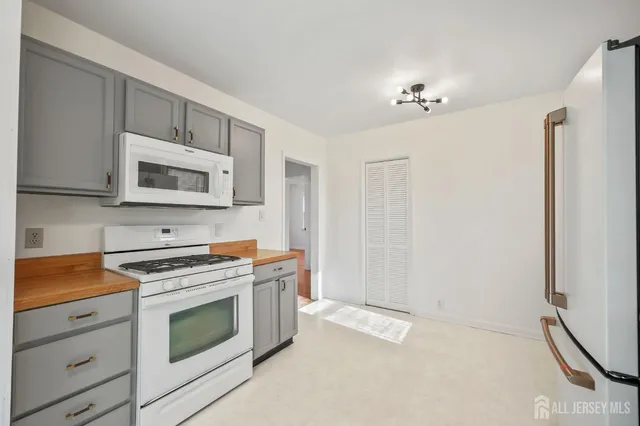 a kitchen with granite countertop cabinets stainless steel appliances and a counter space