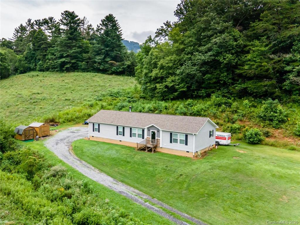 354 Lost Cove Road Clyde, NC 28721 - Photo 1 of 13 a view of house with garden space and trees