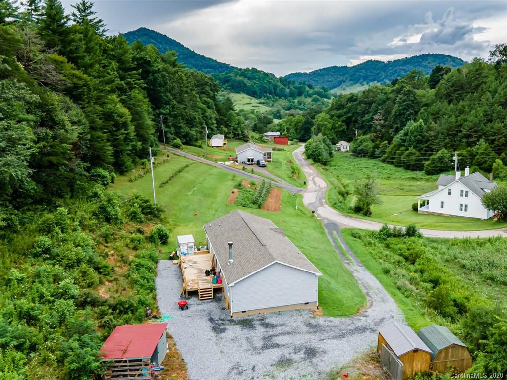 354 Lost Cove Road Clyde, NC 28721 - Photo 2 of 13 an aerial view of a house with a garden