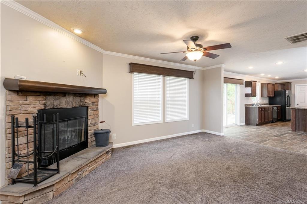 354 Lost Cove Road Clyde, NC 28721 - Photo 5 of 13 a view of an empty room with a fireplace and a window