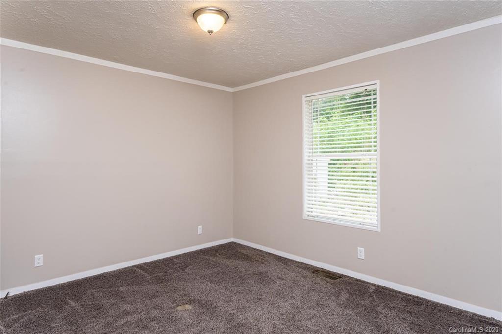 354 Lost Cove Road Clyde, NC 28721 - Photo 7 of 13 an empty room with a window