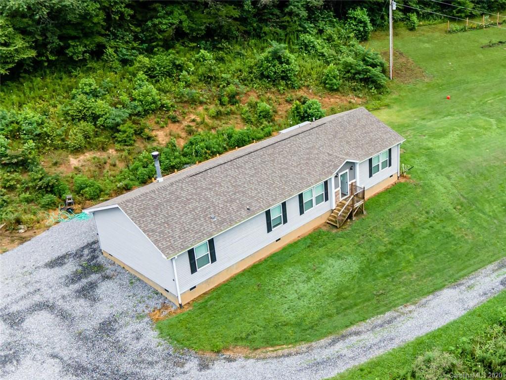 354 Lost Cove Road Clyde, NC 28721 - Photo 10 of 13 a view of a house with a backyard
