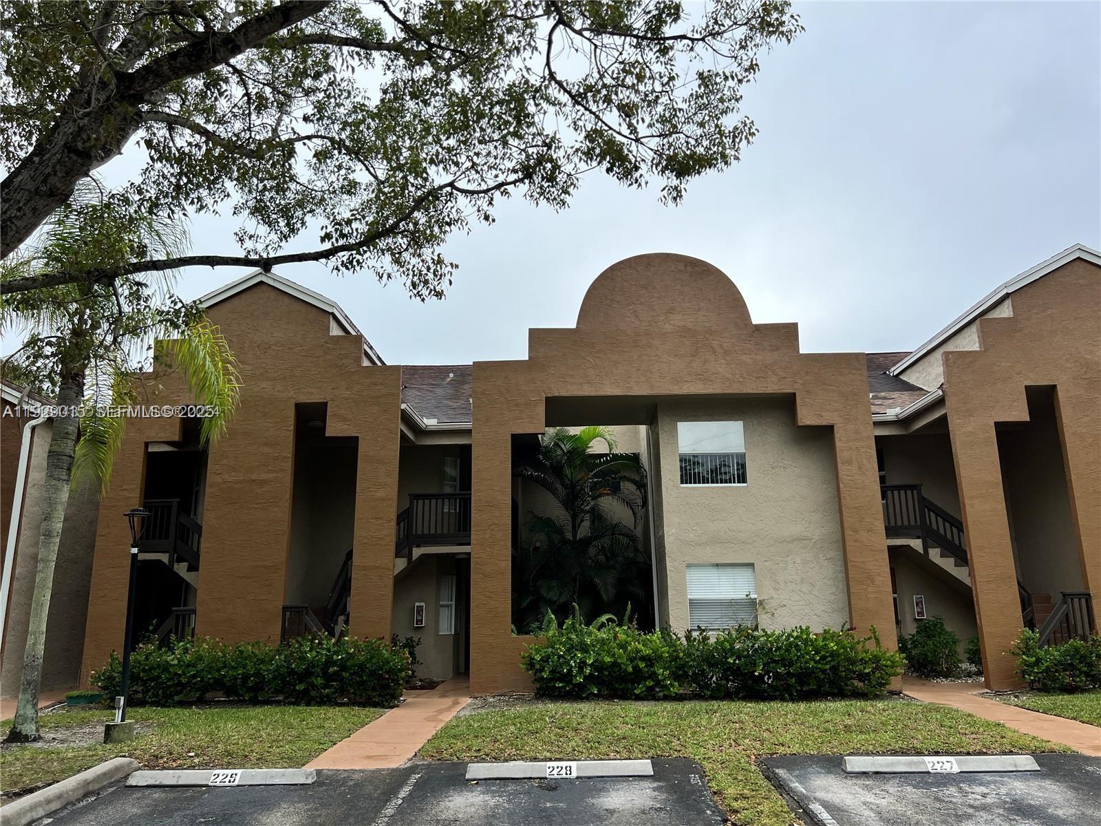 665 Southwest 113th Way, Unit 665 Pembroke Pines, FL 33025 - Photo 1 of 24 a front view of a house with garden