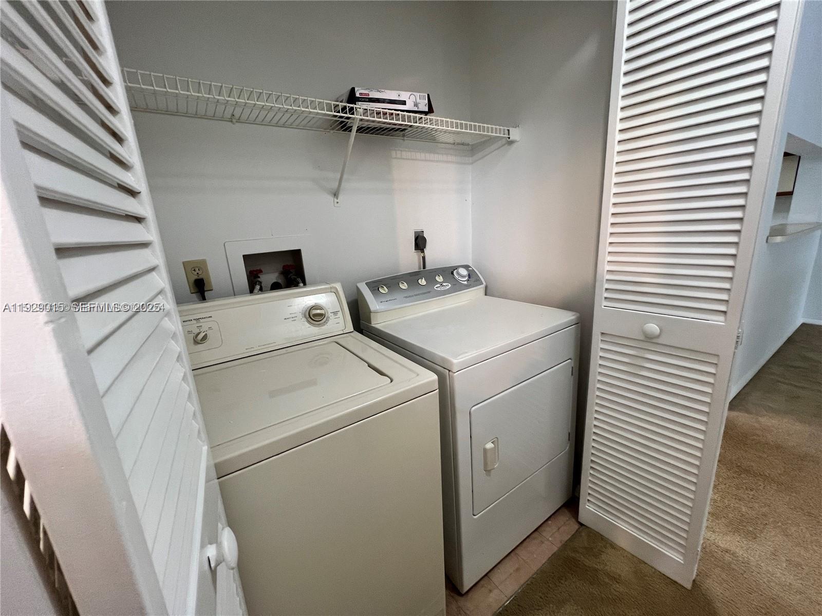 665 Southwest 113th Way, Unit 665 Pembroke Pines, FL 33025 - Photo 16 of 24 a utility room with dryer and washer