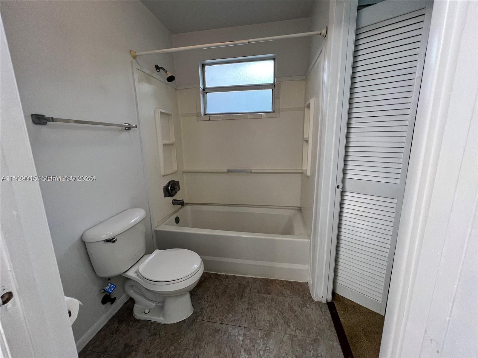 665 Southwest 113th Way, Unit 665 Pembroke Pines, FL 33025 - Photo 18 of 24 a white toilet sitting next to a bath tub