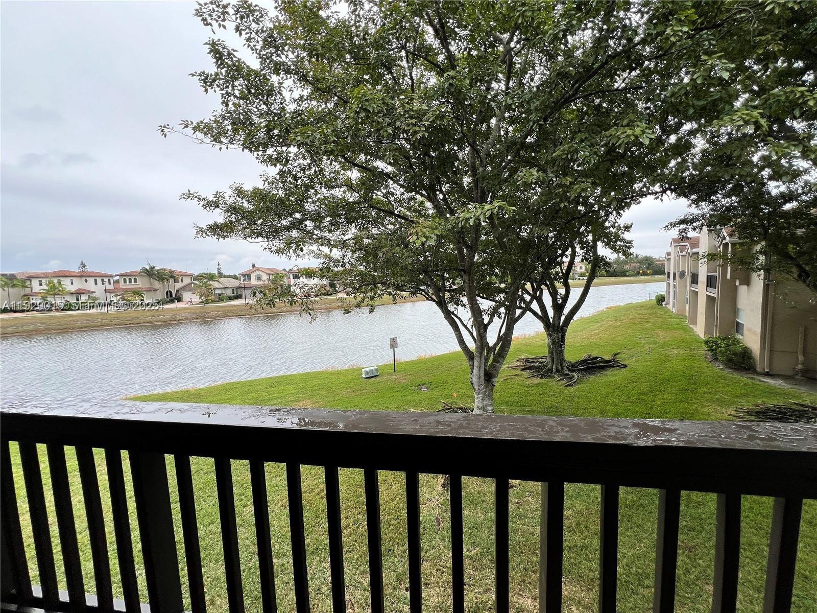 665 Southwest 113th Way, Unit 665 Pembroke Pines, FL 33025 - Photo 20 of 24 a view of balcony with wooden floor and fence