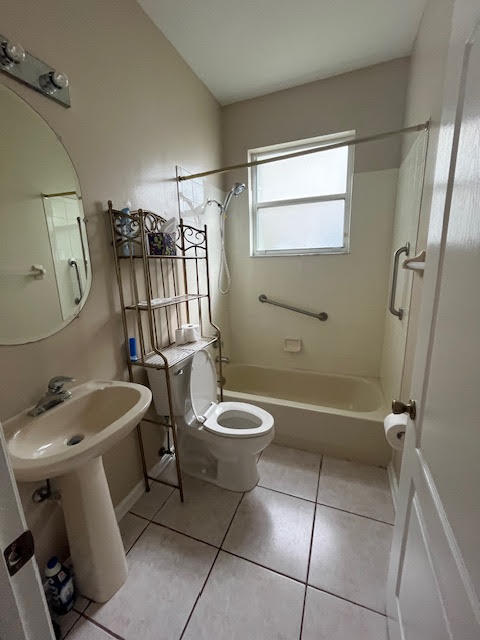 895 Northwest Sassafras Terrace Stuart, FL 34994 - Photo 13 of 23 a bathroom with a toilet sink and mirror