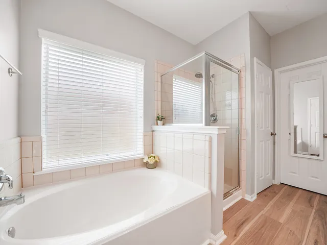 a bathroom with a bathtub and a shower