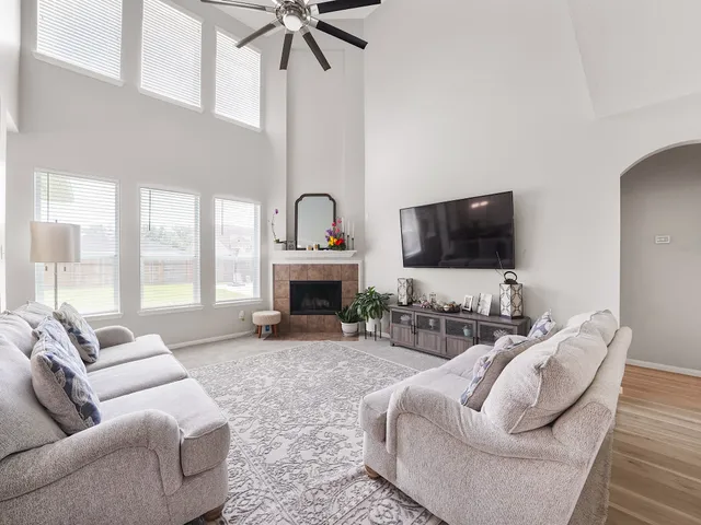 a living room with furniture a fireplace and a flat screen tv