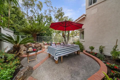 a view of a chairs and tables in the back yard of the house