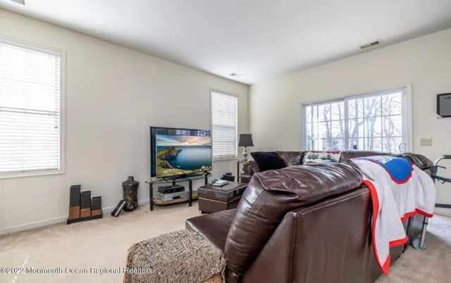 a bedroom with a bed gym equipment and a window