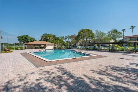 a view of a swimming pool with a yard