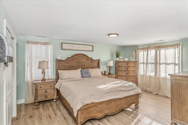 a bedroom with a bed and a large window