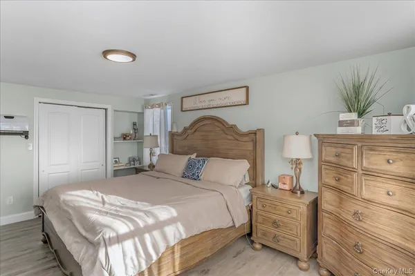 a bedroom with a bed and a potted plant