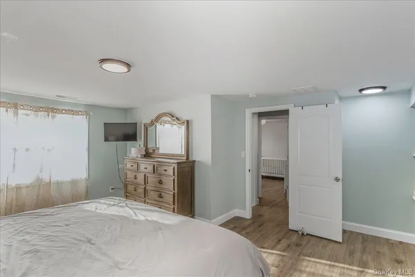 a bedroom with a bed and a dresser