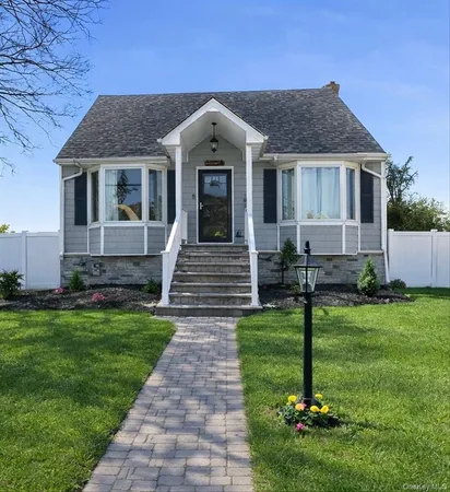 a front view of a house with a garden