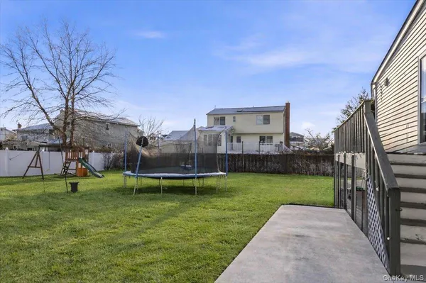 a view of a house with a yard and a porch