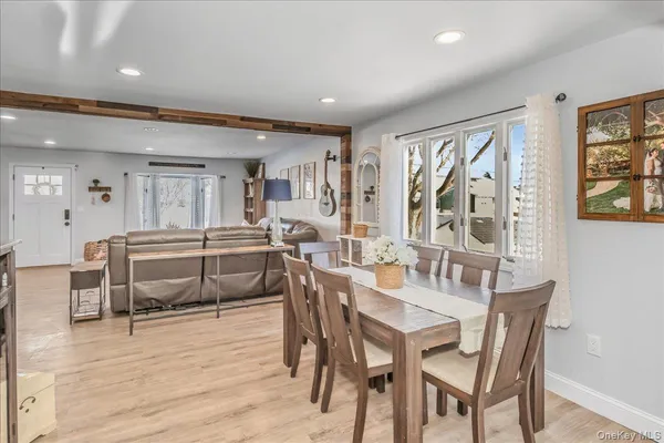 a dining room with furniture and wooden floor