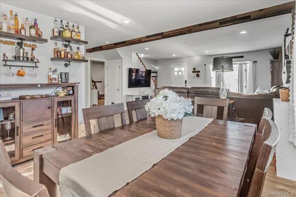 a view of a dining room with furniture and a kitchen