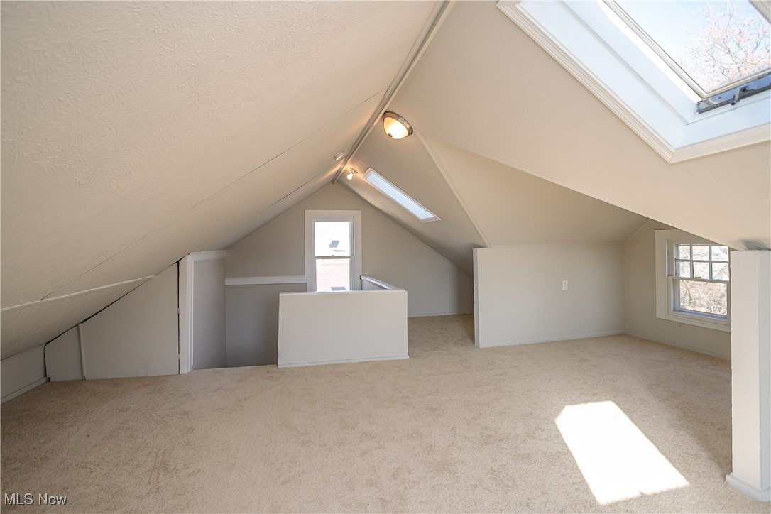 3666 Ludgate Road Cleveland, OH 44120 - Photo 20 of 22 Bonus room with light carpet, a textured ceiling, and lofted ceiling with skylight