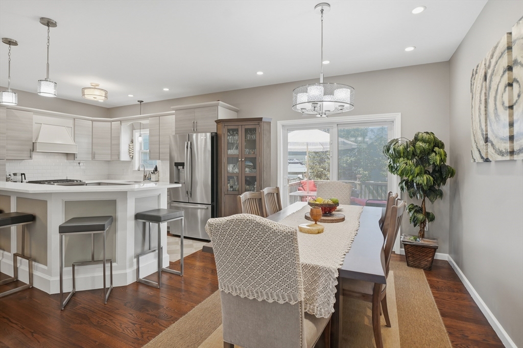 112 Pineland Avenue Worcester, MA 01604 - Photo 11 of 38 a dining room with furniture a chandelier and wooden floor