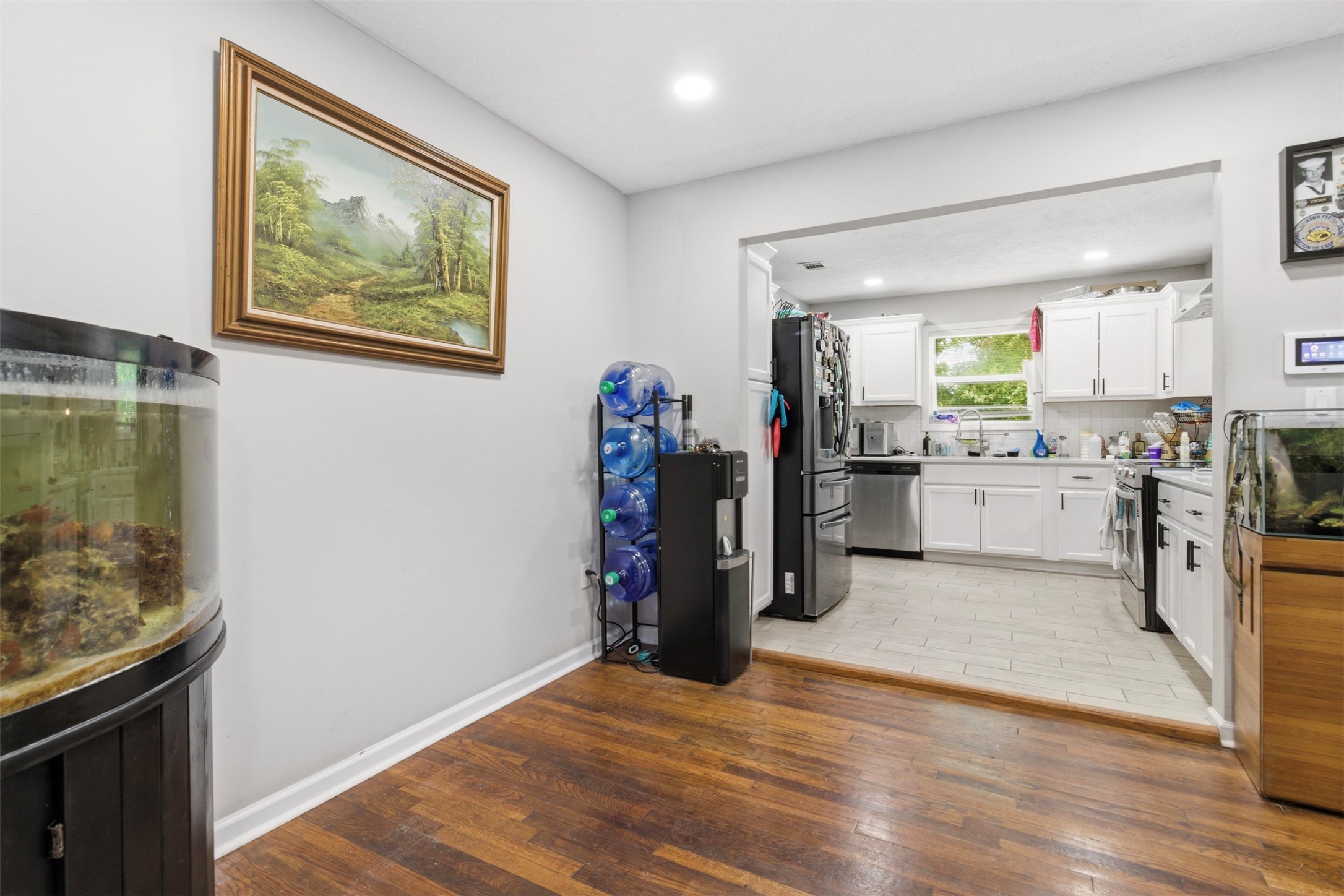 306 Center Street Pasadena, TX 77506 - Photo 9 of 31 a view of a kitchen with fridge and wooden floor